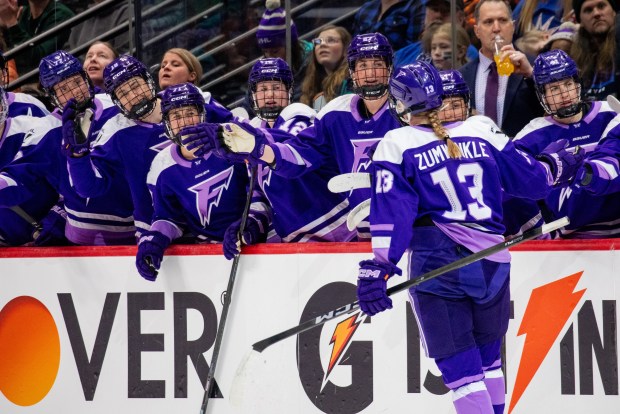 Grace Zumwinkle gets cheers from her Minnesota Frost teammates after scoring one of her two goals in Sunday's 4-3 win over the New York Sirens at Ball Arena in Denver. (Danielle Hersch/PWHL)