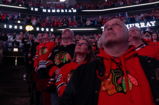 Chicago Blackhawks fans stand during a moment of silence for Troy Murray in the first period of a game against the Mammoth on Monday, March, 9, 2026, at the United Center. (Josh Boland/Chicago Tribune)