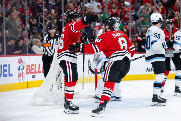 Chicago Blackhawks left wing Andrew Mangiapane (26) celebrates after scoring with center Ryan Donato (8) in the first period against the Mammoth on Monday, March, 9, 2026, at the United Center. (Josh Boland/Chicago Tribune)