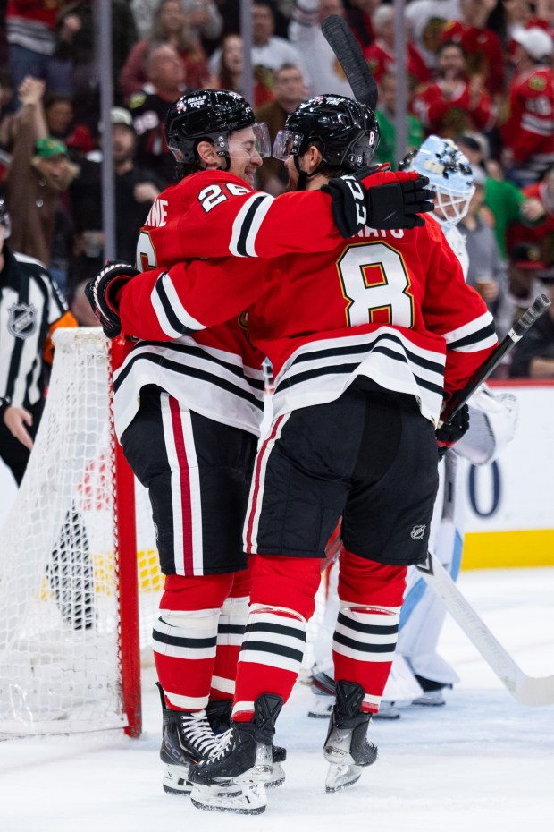Chicago Blackhawks left wing Andrew Mangiapane (26) celebrates after scoring with center Ryan Donato (8) in the first period against the Mammoth on Monday, March, 9, 2026, at the United Center. (Josh Boland/Chicago Tribune)