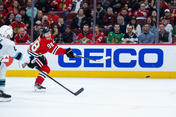 Chicago Blackhawks center Connor Bedard (98) shoots the puck past Utah Mammoth defenseman Ian Cole in the second period against the Mammoth on Monday, March, 9, 2026, at the United Center. (Josh Boland/Chicago Tribune)