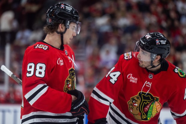 Chicago Blackhawks center Connor Bedard (98) speaks to defenseman Wyatt Kaiser (44) in the second period against the Mammoth on Monday, March, 9, 2026, at the United Center. (Josh Boland/Chicago Tribune)