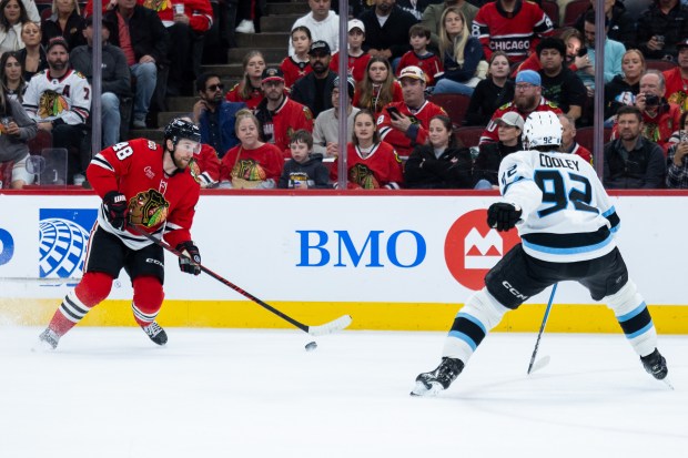 Chicago Blackhawks defenseman Matt Grzelcyk (48) skates with the puck against Utah Mammoth center Logan Cooley (92) in the second period against the Mammoth on Monday, March, 9, 2026, at the United Center. (Josh Boland/Chicago Tribune)
