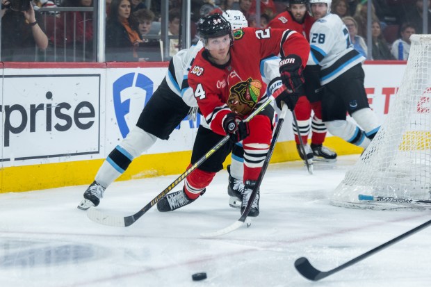 Chicago Blackhawks center Sam Lafferty (24) passes the puck in the third period against the Mammoth on Monday, March, 9, 2026, at the United Center. (Josh Boland/Chicago Tribune)