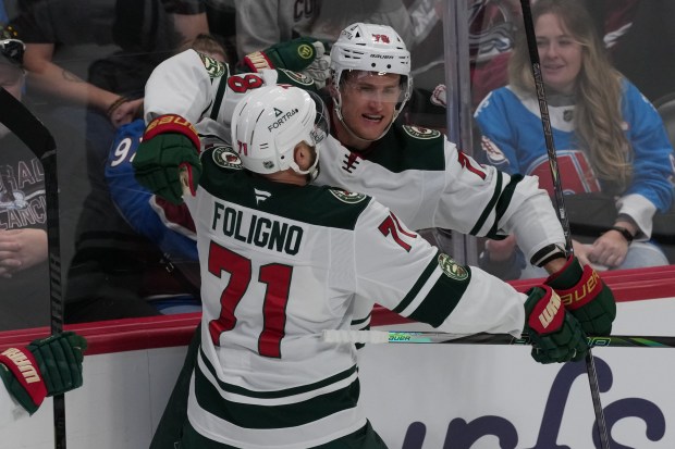 Wild center Nico Sturm is congratulated by left wing Nick Foligno (71) after scoring a goal in the third period against the Avalanche on March 8, 2026, in Denver. (AP Photo/David Zalubowski)