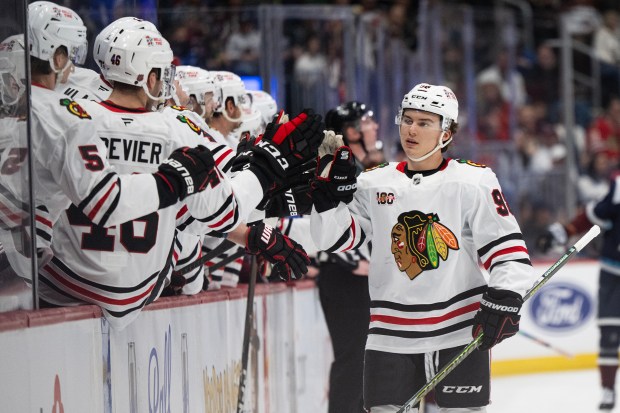 Blackhawks center Connor Bedard taps gloves with teammates on the bench after scoring against the Avalanche during the first period Saturday, Feb. 28, 2026, in Denver. (Timothy Hurst/Denver Post)