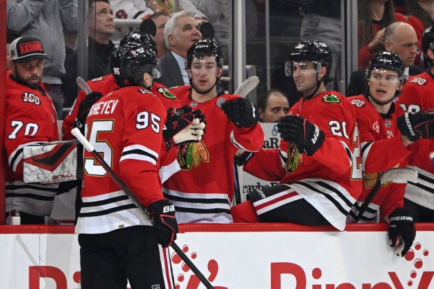 Ilya Mikheyev taps gloves with his Blackhawks teammates after scoring a goal during the first period against the Canucks on Friday, March 6, 2026, at the United Center. (Paul Beaty/AP)