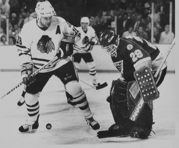 Blackhawks center Troy Murray, left, and Blues goaltender Greg Millen follow puck during the 1989 Stanley Cup playoffs. (AP file)