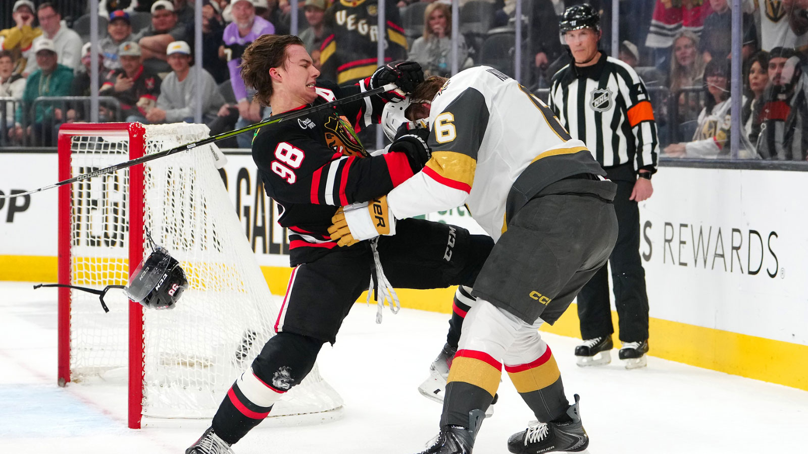 Chicago Blackhawks center Connor Bedard (98) looks to fight Vegas Golden Knights defenseman Kaedan Korczak (6) during the first period at T-Mobile Arena. 