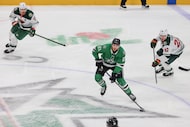 Dallas Stars left wing Jason Robertson (21) looks to pass Minnesota Wild right wing Danila...