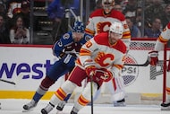 Calgary Flames left wing Blake Coleman (20) collects the puck as Colorado Avalanche right...