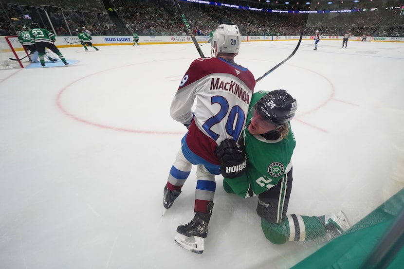 Colorado Avalanche center Nathan MacKinnon (29) and Dallas Stars center Roope Hintz (24)...