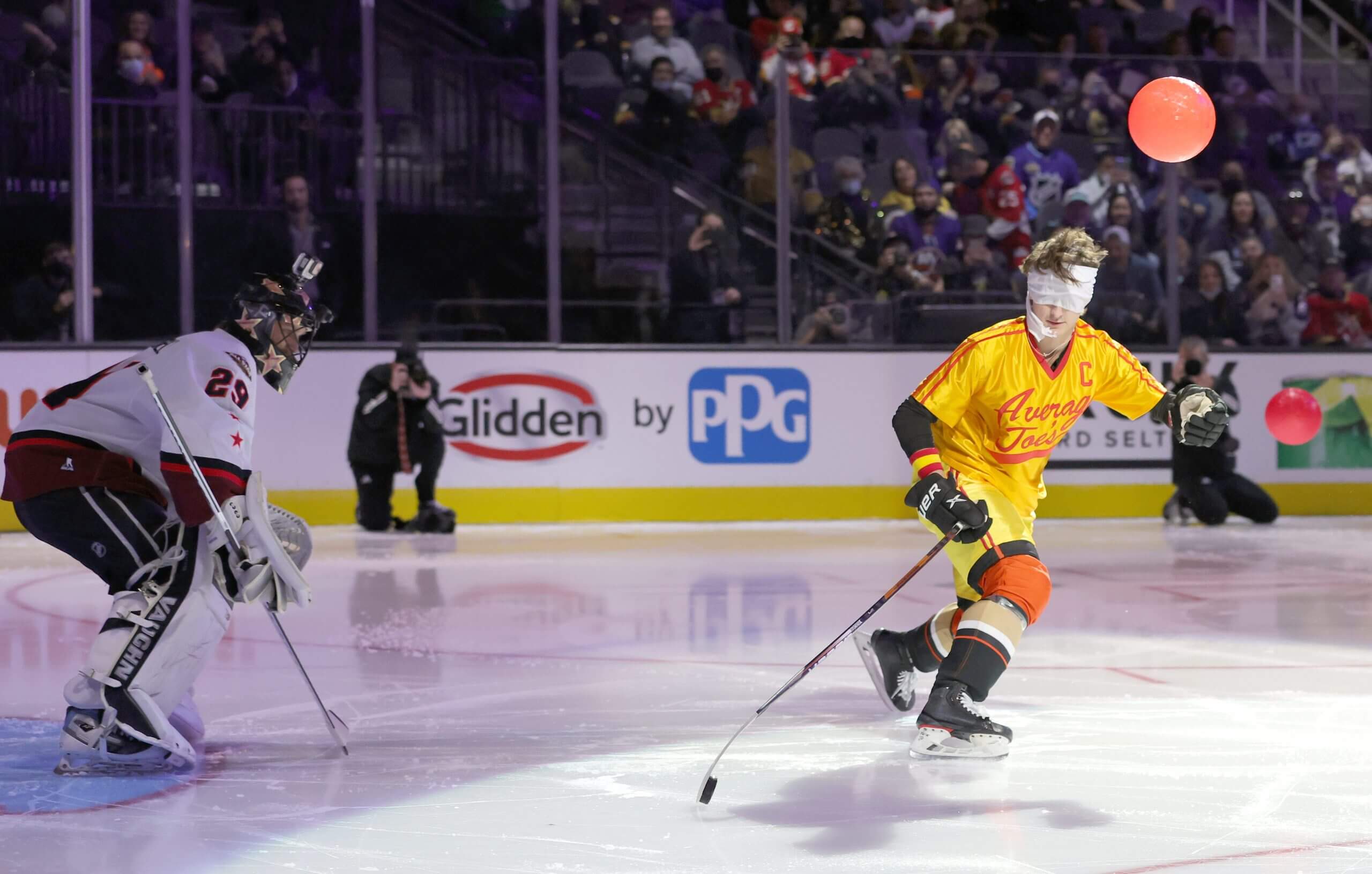 Trevor Zegras, dressed as the character Peter LaFleur from the movie 'Dodgeball: A True Underdog Story,' shoots the puck while blindfolded against actor Wyatt Russell in the Breakaway Challenge of the 2022 NHL All-Star Skills at T-Mobile Arena in Las Vegas in February 2022. (Ethan Miller / Getty Images)