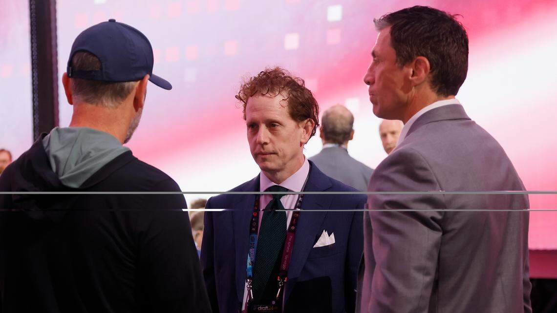Tom Dundon, left, Eric Tulsky, center, and Rod Brind'Amour chat during the 2024 NHL Draft at Sphere on June 29, 2024, in Las Vegas, Nevada.