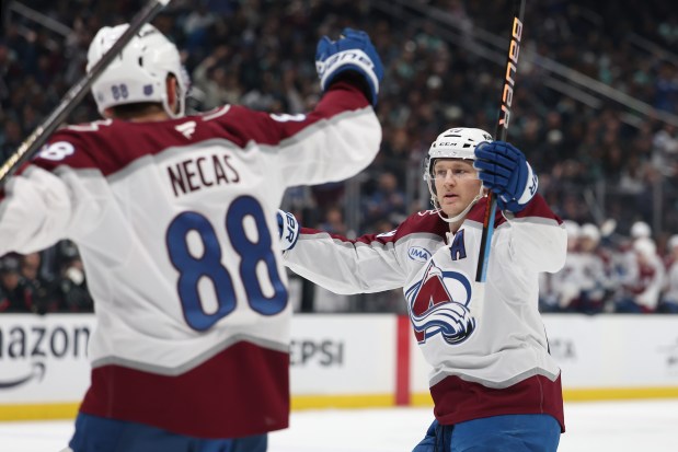 Martin Necas of the Colorado Avalanche celebrates his goal with Nathan MacKinnon during the first period against the Seattle Kraken at Climate Pledge Arena on March 12, 2026 in Seattle, Washington. (Photo by Steph Chambers/Getty Images)