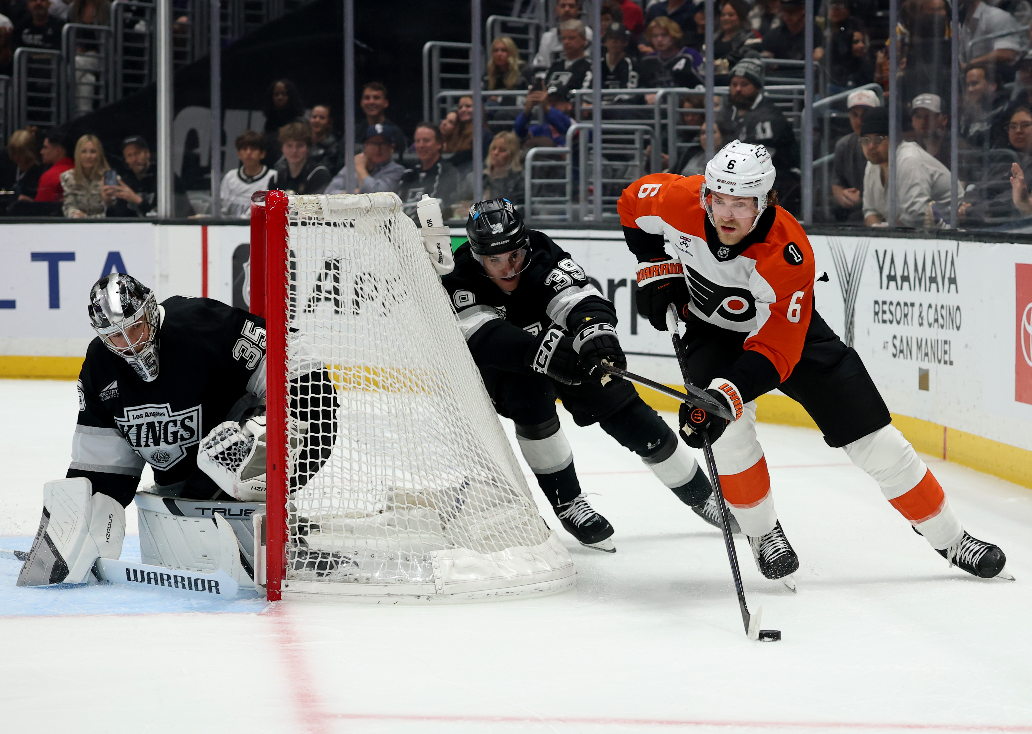 The Philadelphia Flyers’ Travis Sanheim , right, skates behind Kings...