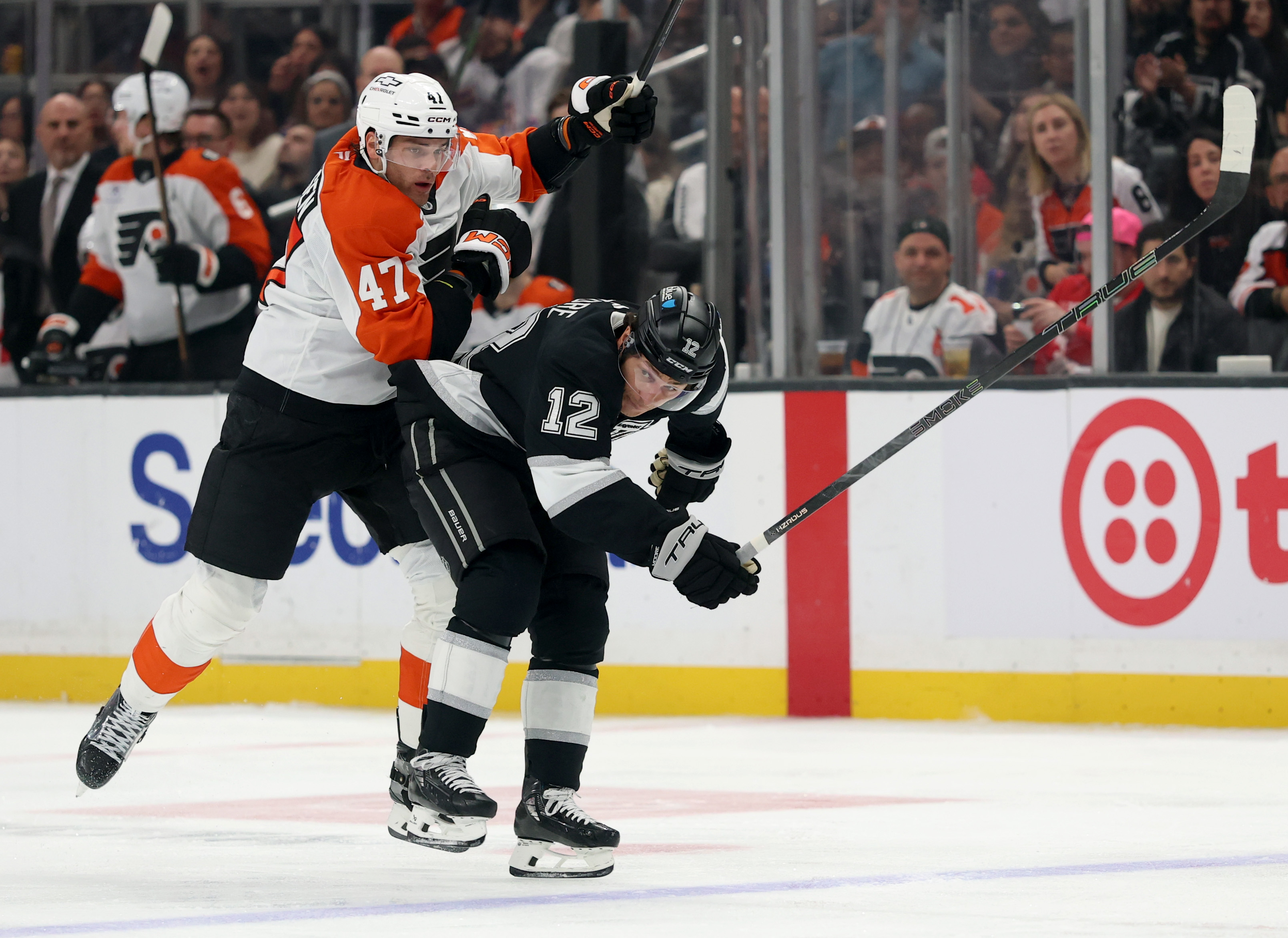 The Kings’ Trevor Moore, right, collides with the Philadelphia Flyers’...