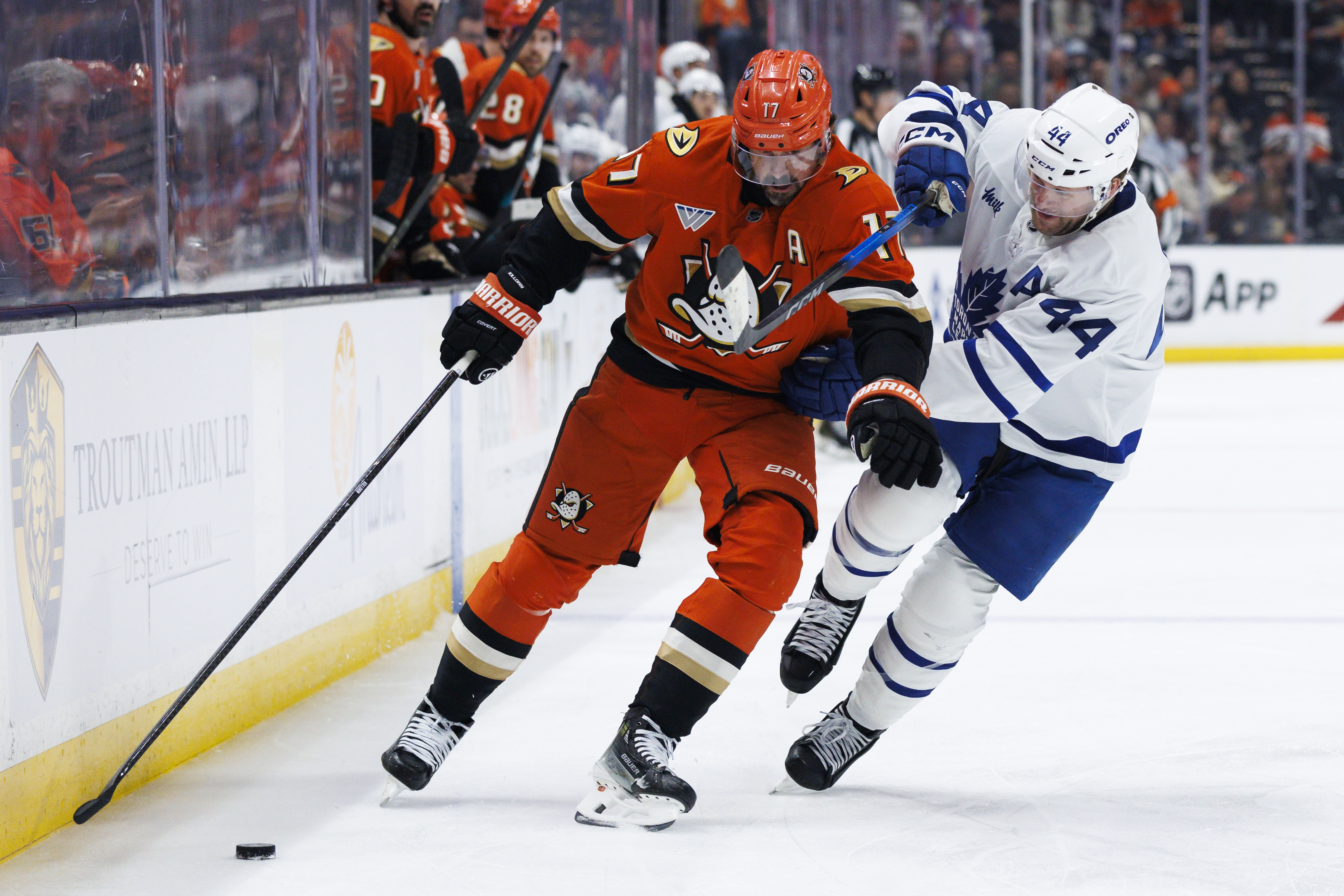 The Ducks’ Alex Killorn, left, skates with the puck while...