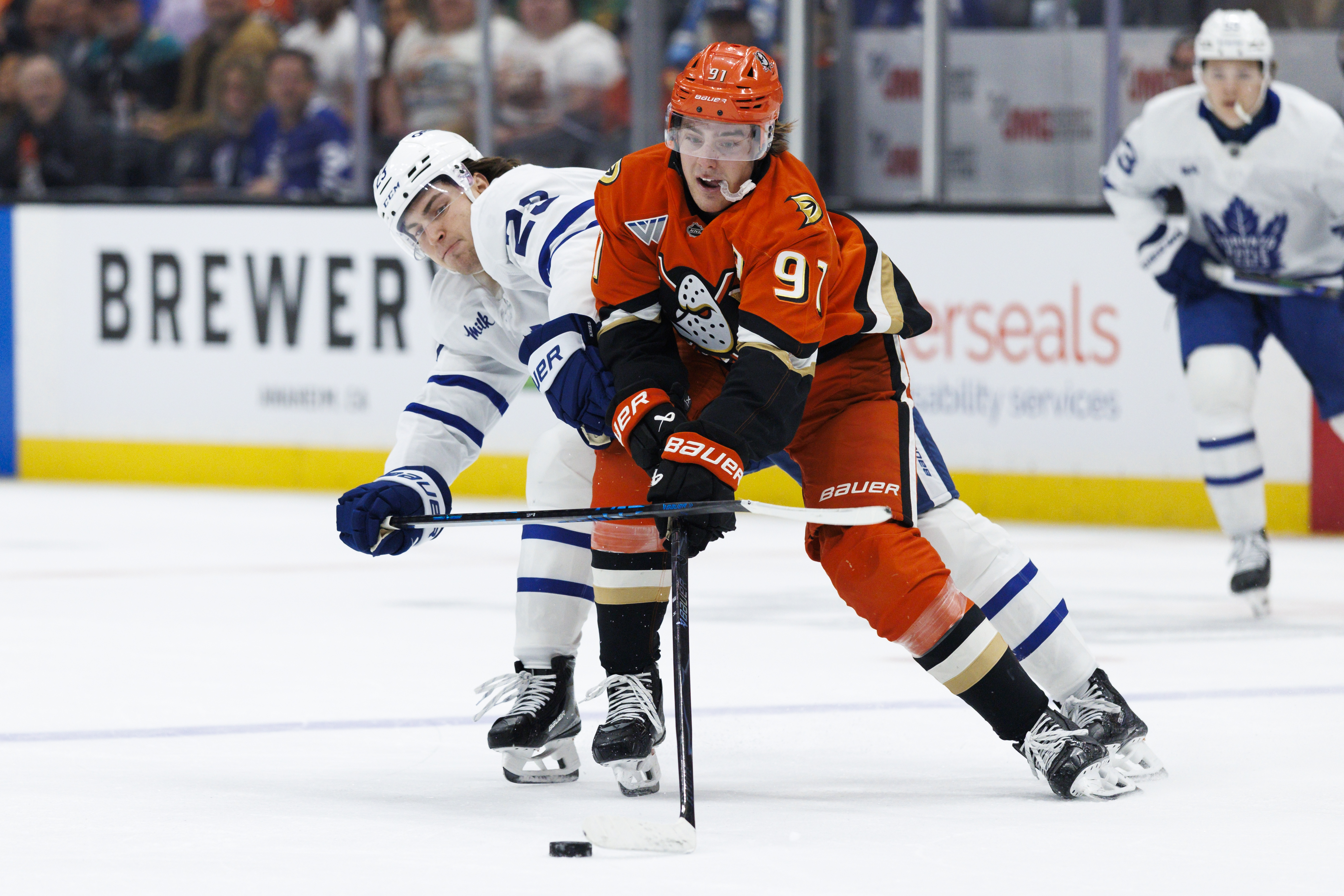 The Ducks’ Leo Carlsson, front, skates with the puck while...
