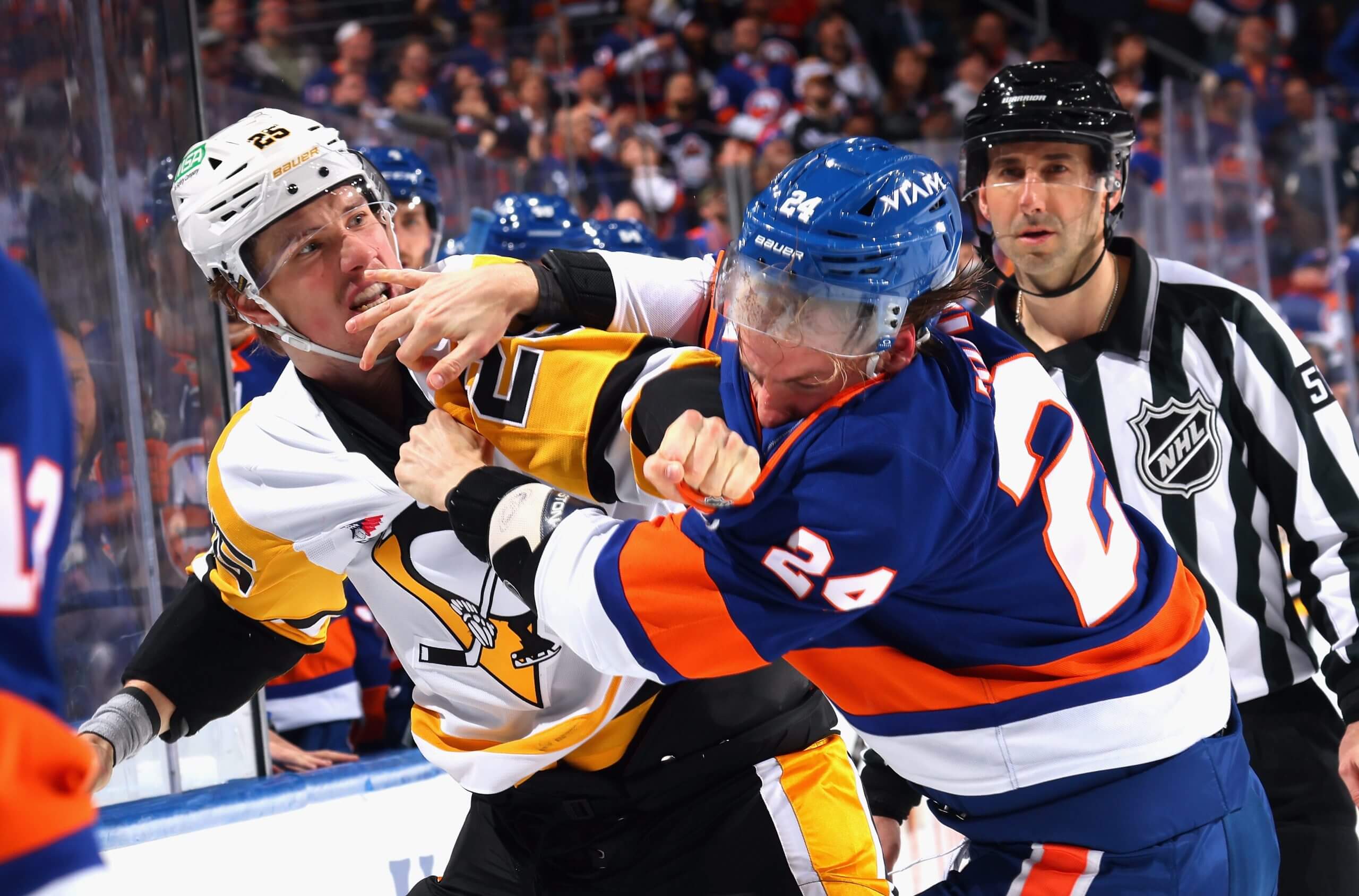 Elmer Soderblom and Scott Mayfield throw punches with a ref looking on.