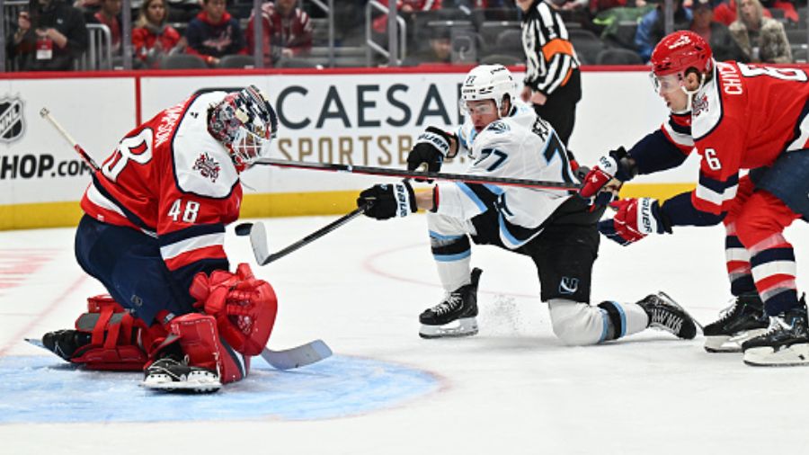 Goaltender Logan Thompson #48 of the Washington Capitals stops a point-blank shot from JJ Peterka #...