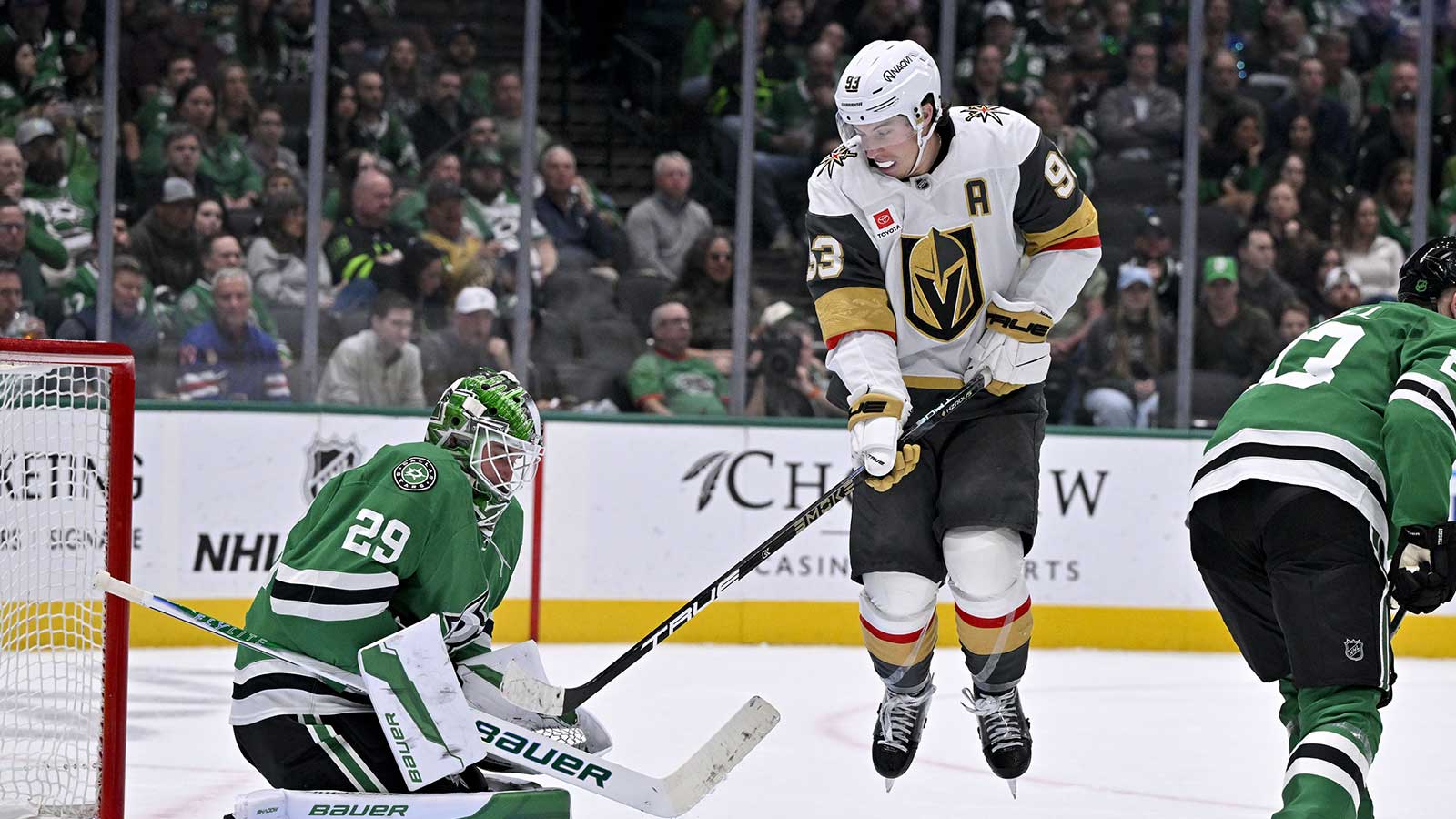Vegas Golden Knights right wing Mitch Marner (93) leaps in front of Dallas Stars goaltender Jake Oettinger (29) during the third period at the American Airlines Center.