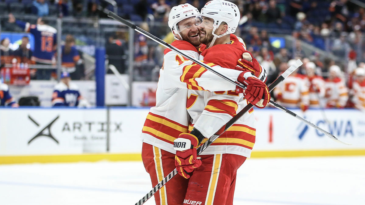 Calgary Flames defenseman MacKenzie Weegar (52) is greeted by center Jonathan Huberdeau (10) after scoring his third goal of the game in the third period New York Islanders at UBS Arena.