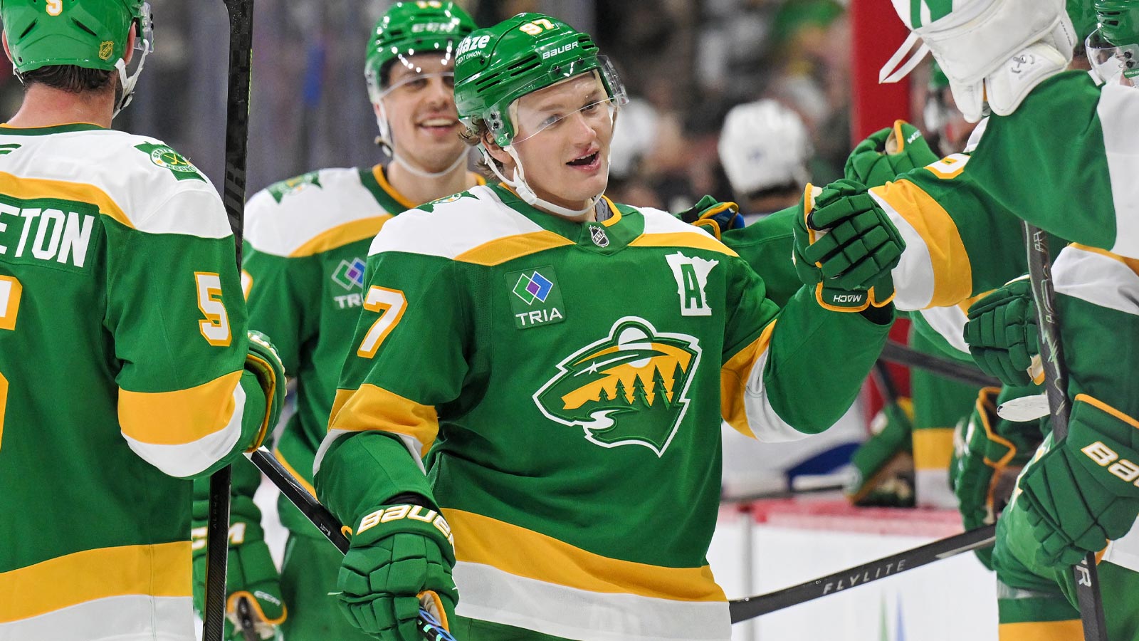 Minnesota Wild forward Kirill Kaprizov (97) is congratulated by teammates after taking sole possession as the franchise leader in goals on an empty netter against the Tampa Bay Lightning during the third period at Grand Casino Arena. 