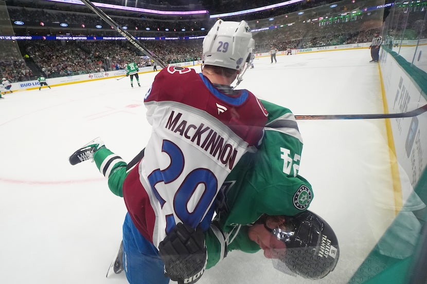 Colorado Avalanche center Nathan MacKinnon (29) and Dallas Stars center Roope Hintz (24)...