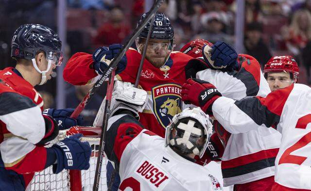 Florida Panthers left wing A.J. Greer (10) gets into a scuffle against the Carolina Hurricanes in the third period of their NHL game at Amerant Bank Arena on Friday, Dec. 19, 2025, in Sunrise, Fla.