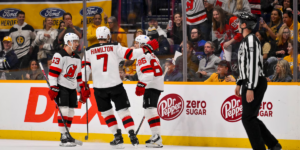 New Jersey Devils' skaters Jesper Bratt, Dougie Hamilton and Jack Hughes celebrate a goal with fans in the first period of Thursday's contest against the Nashville Predators.