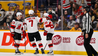 New Jersey Devils' skaters Jesper Bratt, Dougie Hamilton and Jack Hughes celebrate a goal with fans in the first period of Thursday's contest against the Nashville Predators.