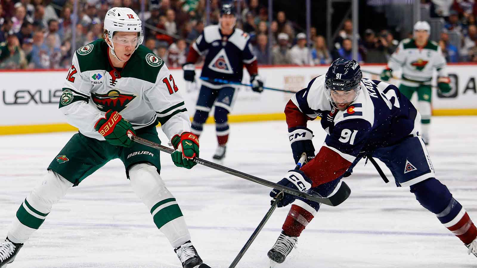 Colorado Avalanche left wing Nazem Kadri (91) steals the puck away from Minnesota Wild left wing Matt Boldy (12) in the first period at Ball Arena.