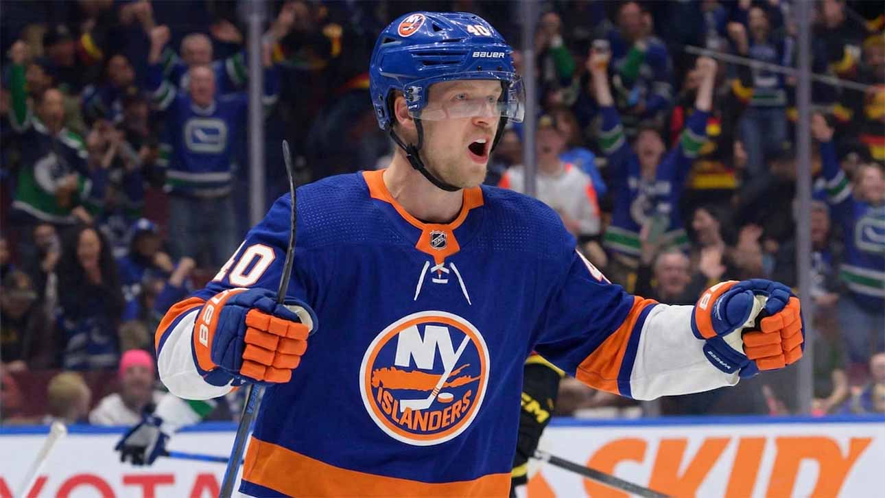 Vancouver Canucks center Elias Pettersson, wearing the 'Flying Skate' retro jersey, celebrating a goal, amidst New York Islanders trade speculation.