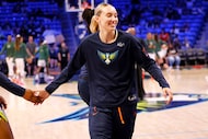 Dallas Wings guard Paige Bueckers (5) gets a high-five before an WNBA basketball game...