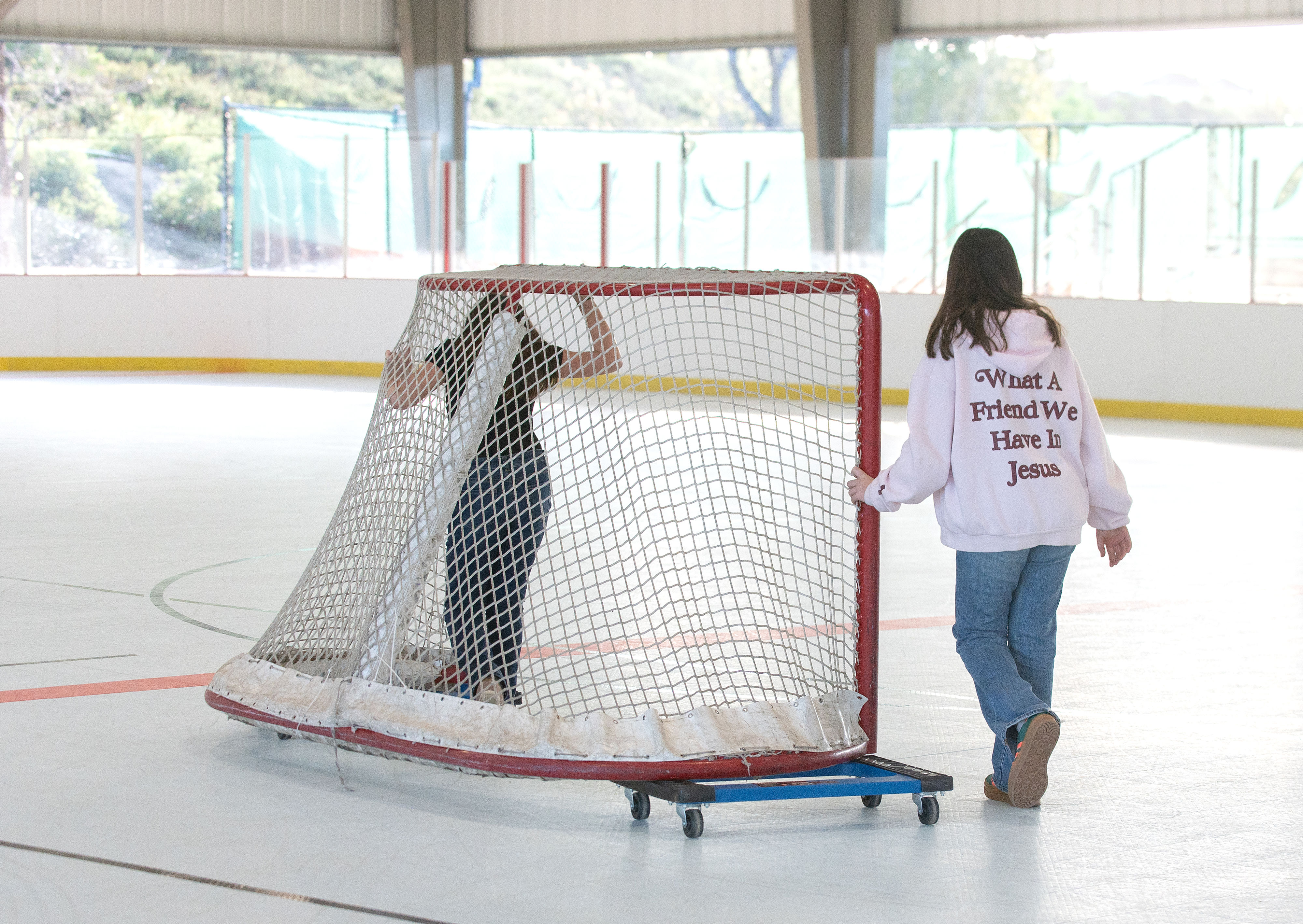 From left, Ava Ciullo and Gianna Ciullo move a hockey...