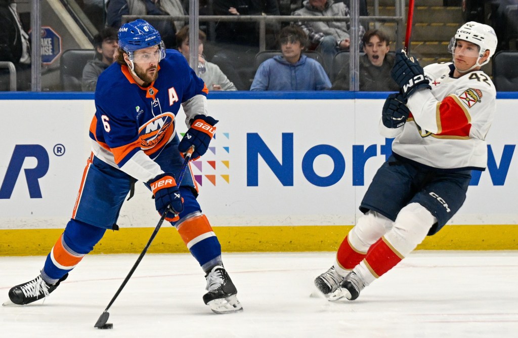 Ryan Pulock attempts a pass as Gustav Forsling defends during the Islanders 5-4 win over the Panthers on March 2, 2026.