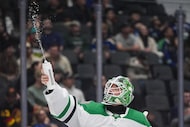 Dallas Stars goalie Jake Oettinger squirts water in the air before the start of the third...
