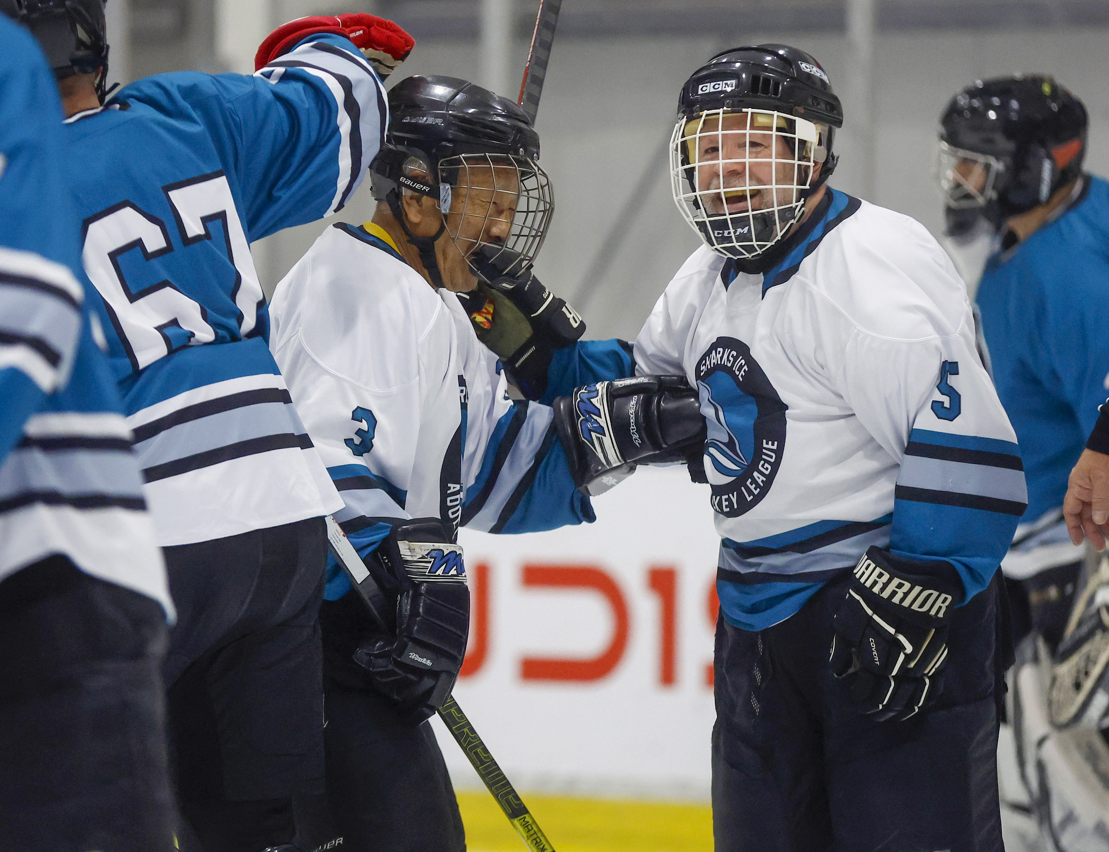 Ed Asato (3), left, 87, from Sunnyvale, celebrates his goal...