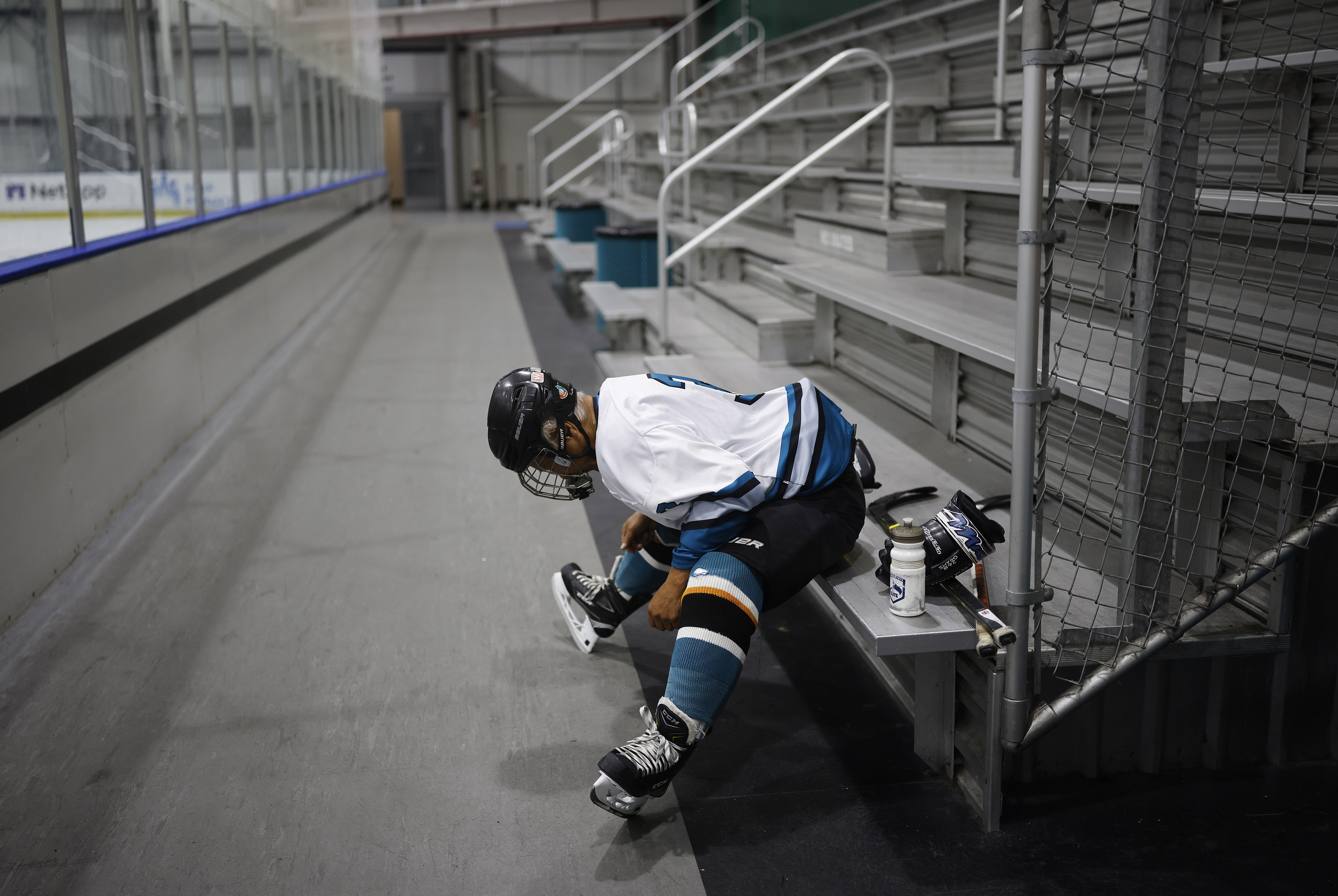 Ed Asato (3), 87, from Sunnyvale, stretches before playing in...