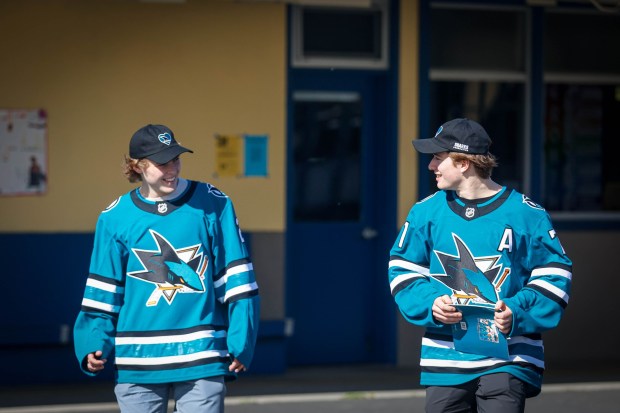 San Jose Sharks' Will Smith and Macklin Celebrini walk towards the library at Bachrodt Elementary in San Jose, Calif., on Thursday, March 5, 2026. (Shae Hammond/Bay Area News Group)