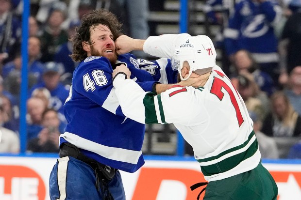 Minnesota Wild left wing Nick Foligno (71) punches Tampa Bay Lightning right wing Scott Sabourin (46) as they fight during the first period of an NHL hockey game Tuesday, March 24, 2026, in Tampa, Fla. (AP Photo/Chris O'Meara)