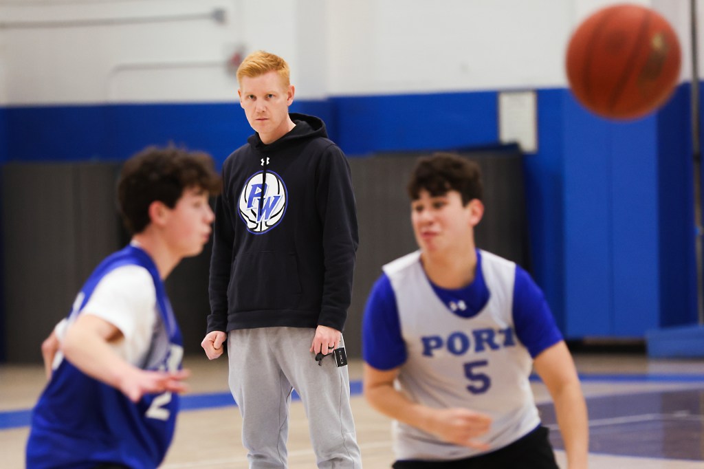 Port Washington boys basketball head coach Sean Dooley (center) watches his team during practice at Paul D. Schreiber High School in Port Washington, N.Y. on March 5, 2026. 