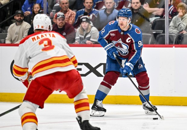 Gabriel Landeskog (92) of the Colorado Avalanche handles as Olli Maatta (3) of the Calgary Flames defends during the first period at Ball Arena in Denver on Monday, March 30, 2026. (Photo by AAron Ontiveroz/The Denver Post)
