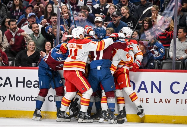 The Colorado Avalanche and the Calgary Flames jostle after Brayden Pachal (94) checked Jack Drury (18) during the first period at Ball Arena in Denver on Monday, March 30, 2026. (Photo by AAron Ontiveroz/The Denver Post)