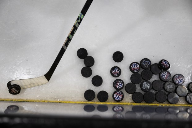 General Manager Dan Brennan flips a puck from the ice during a Team USA Sled Hockey practice on Thursday, Feb. 5, 2026, at a Blue Sport Stable ice rink in Superior. (Photo by Timothy Hurst/The Denver Post)