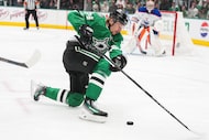 Dallas Stars center Roope Hintz slips to the ice in front of Edmonton Oilers goaltender...
