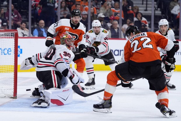 Philadelphia Flyers' Christian Dvorak (22) scores a goal against Chicago Blackhawks' Spencer Knight (30) during the second period of an NHL hockey game Thursday, March 26, 2026, in Philadelphia. (AP Photo/Matt Slocum)