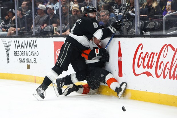 Los Angeles Kings defenseman Drew Doughty checks Philadelphia Flyers right wing Matvei Michkov, bottom right, into the boards during the third period Thursday, March 19, 2026, in Los Angeles. (AP Photo/Jessie Alcheh)