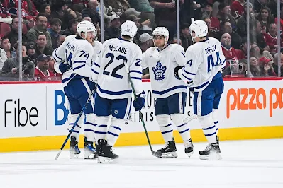 Toronto Maple Leafs players celebrate goal during 2025 game.